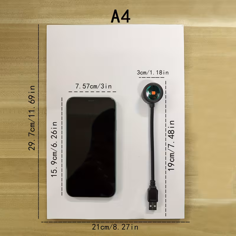 Size comparison of the sunset lamp next to a phone and an A4 sheet